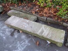 A doorway lintel or similar and a further stone slab