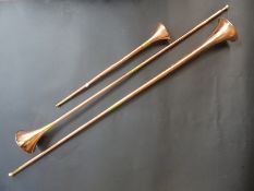 A set of three graduated copper coaching horns with brass fittings