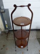 A mahogany three tier cake stand