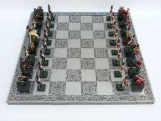 Battle of Waterloo chess set in the form of Napoleonic soldiers, on silver coloured board.