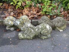 Three reconstitued stone lions with spheres