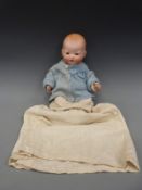 An Armand Marseille bisque headed baby doll with open mouth,