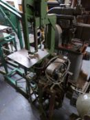 A band saw and belt sander on combined stand