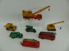 Seven Dinky Toys and Supertoys diecast model vehicles including fire engines, cranes, road roller,