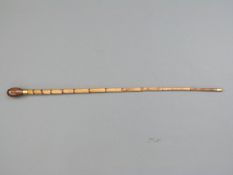 A bamboo shafted knobkerrie with brass tip and collar,