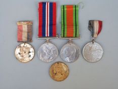 A pair of WWII medals and three 1930's Royal commemorative medals