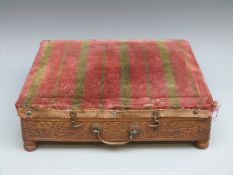 An upholstered carved oak campaign footwarmer with original tin water container (29 x 26cm)