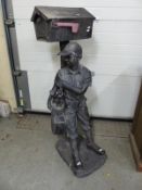 A shop display model of a young golf caddy in old fashioned attire,