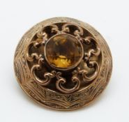 A Victorian brooch with engraved decoration and set with a citrine, 3.3cm, 9.