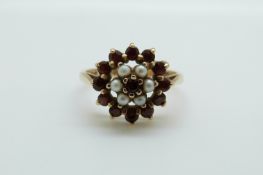 A 9ct gold ring set with garnets and seed pearls, 3.