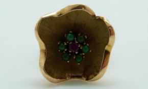 A 9ct gold ring in the form of a flower set with a ruby surrounded by turquoise, 5.