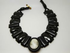 A Victorian jet necklace made up of faceted beads and a cameo centre