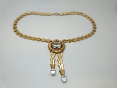 A Tiffany & Co 14k gold necklace set with an emerald cut aquamarine measuring approximately 9ct