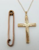 A 9ct gold cross pendant (2g) and a yellow metal brooch marked 15ct (3.