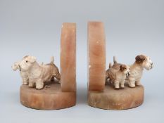 A pair of Art Deco onyx bookends cold painted bronze Sealyham terriers with puppies, H11.