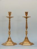 A pair of bronze or similar cast hexagonal candlesticks,