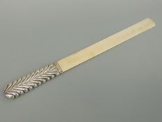 A hallmarked silver and ivory page turner, the handle with moulded feather decoration, London 1891,