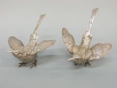 A pair of white metal stylised birds, marked to wings 925 sterling, length 14cm,