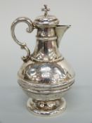 A Victorian hallmarked silver ecclesiastical pedestal wine jug, with cork top and cross surmount,