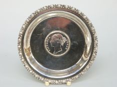 A white metal dish set with an 1840 Rupee, marked silver to rim, diameter 9.