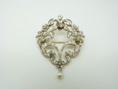 An early 20thC brooch set with diamonds in a floral/ foliate design and a drop pearl, 4.2 x 3.