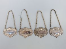 A set of four plated bottle tickets or spirit labels
