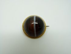 A Victorian yellow metal brooch set with a banded agate cabochon, 2.