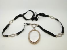 A 20thC Belle Epoque diamond pendant/ locket suspended from a circular wreath,