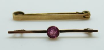 A 9ct gold brooch set with a pink paste and a yellow metal brooch