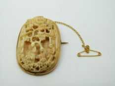 A Chinese Cantonese ivory panel depicting figures in a 9ct gold Victorian brooch mount