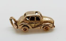 A 9ct gold charm in the form of a car, 4.
