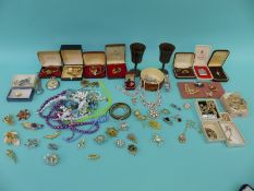 A collection of costume jewellery including brooches, necklaces, beads, Smiths pocket watch,