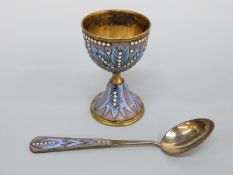 A silver gilt and enamelled egg cup and spoon with impressed 916 and worker's head mark