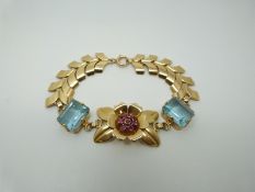 A Tiffany & Co 14k gold bracelet set with a cluster of rubies in a floral and foliate setting