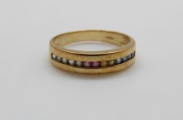 A 9ct gold ring set with a line of multicoloured sapphires, 3.