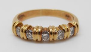 An 18ct gold ring set with diamonds, 5.