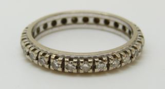 A white metal eternity ring set with diamonds (size L)