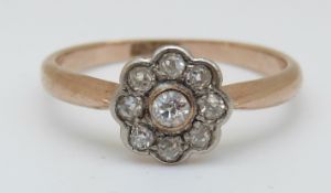 An 18ct gold ring set with diamonds in a daisy cluster, 2.