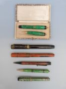 Seven vintage pens and pencils including George Parker green marbled pair,