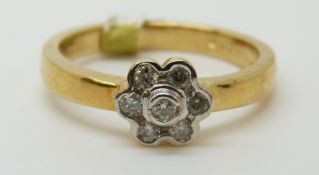 An 18ct gold ring set with diamonds in a cluster, total diamond weight approximately 0.2ct, 5.
