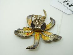 A hallmarked silver brooch set with enamel and paste in the form of a lily, London 1947, 6.8 x 7.