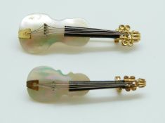 Two brooches in the form of violins set with mother of pearl,