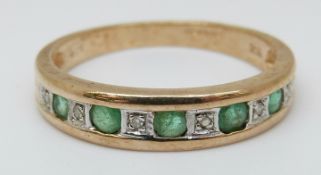 A 9ct gold ring set with alternating emeralds and diamonds (size P)