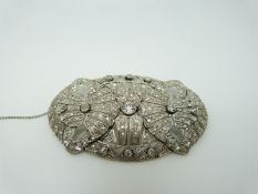 A large Art Deco diamond set brooch, the central old mine cut diamond measuring approximately 0.
