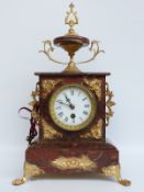A burgundy marbled and ormolu clock, the Roman dial with gilt bezel and beetle and poker hands,