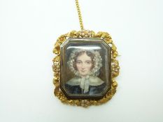 A Victorian mourning brooch set with a portrait miniature of a young woman,