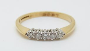 An 18ct gold ring set with five diamonds totalling approximately 0.2ct, 2.