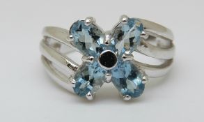 A 9ct white gold ring set with blue topaz in flower cluster (size N)
