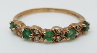 A 9ct gold ring set with a emeralds and diamonds (size N)