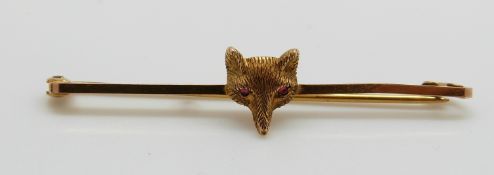A 9ct gold brooch in the form of a fox's head set with red paste eyes, 1.